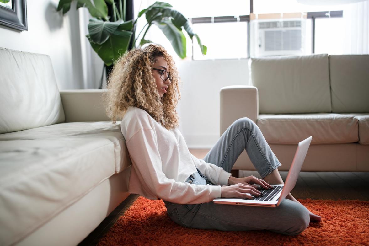 curly hair woman working from home on computer 